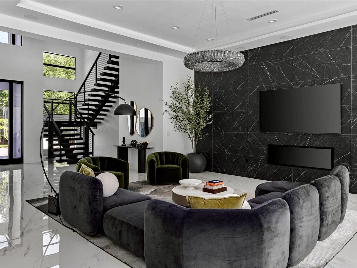 Great room with large-format black marble feature wall and white marble floor